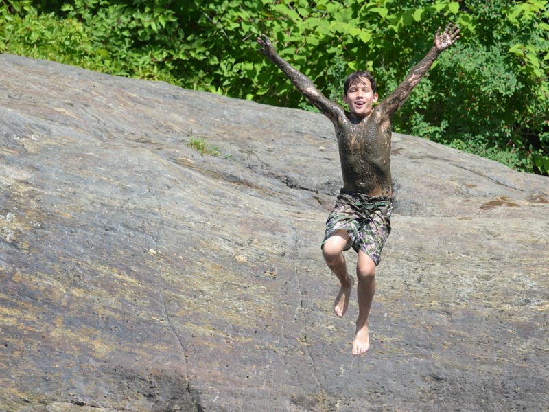 This camper is embracing the Mud City lifestyle 100%. Here is one of our Stowe VT campers jumping into the river off of a small rock.