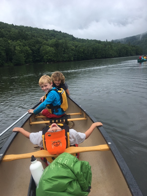 We like to teach kids valuable life skills and wilderness survival skills. Here is one of our campers fishing with a net and a bucket in the Little River in Stowe Vermont.