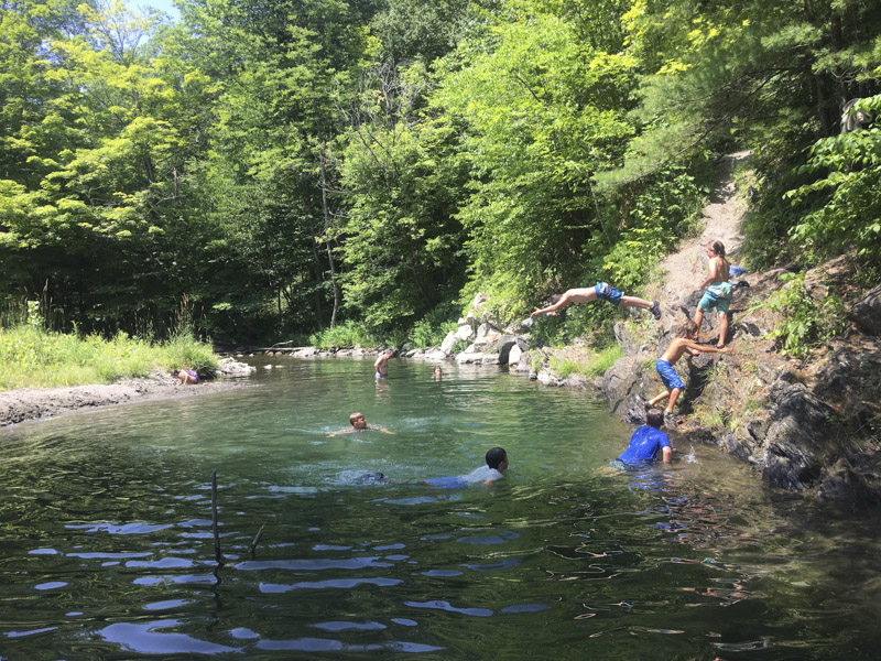 This camper is embracing the Mud City lifestyle 100%. Here is one of our Stowe VT campers jumping into the river off of a small rock.