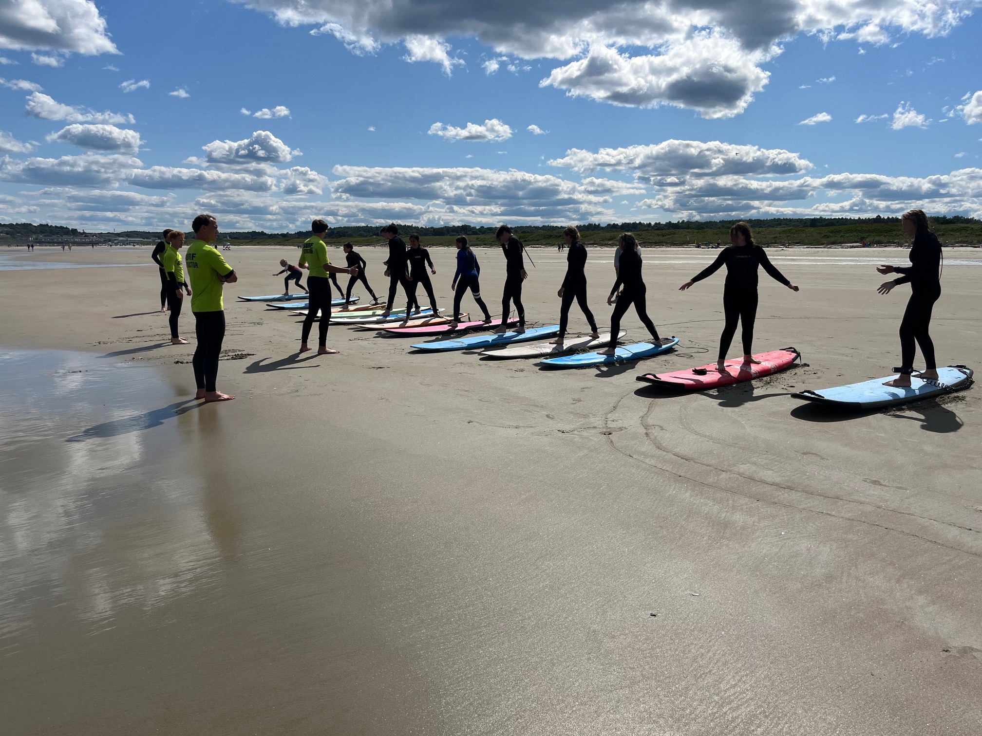 Before we head into the water, we'll show the kids the basics of paddling, both into the break and into the wave. It's also where we'll teach them how to get from their bellies onto their feet.